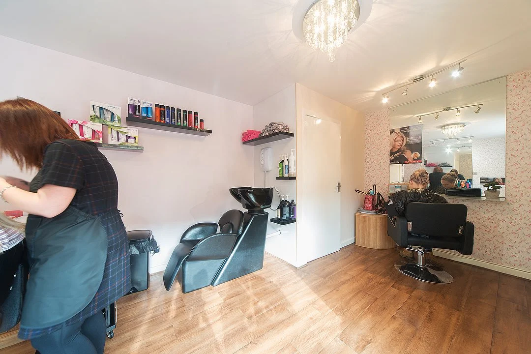 Inside The Hair Cottage, with styling mirrors, salon chairs and a wash basin